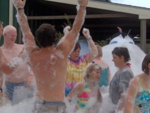 group of people dancing in a mountain of bubbles